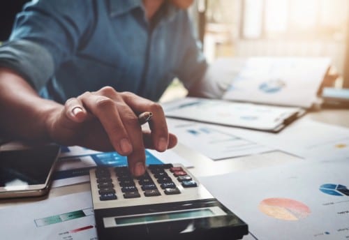 Business man using calculator