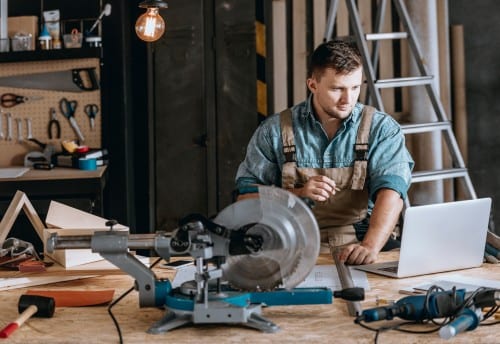 Bearded carpenter planning woodworking project