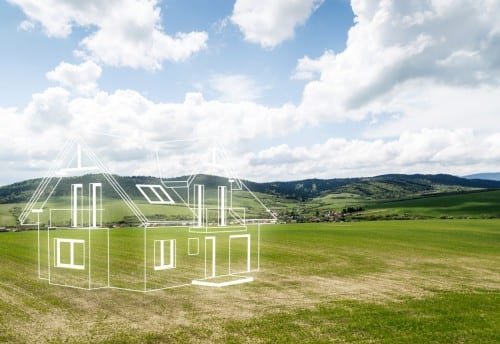 Green fields with transparent house outline