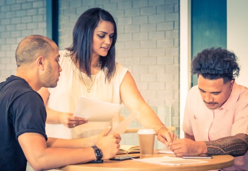 three young accountants reviewing documents