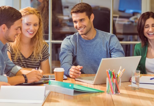 Group of young colleagues using laptop