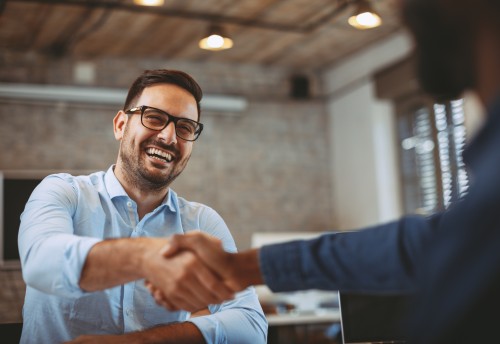 Close up of a happy handshake in the office