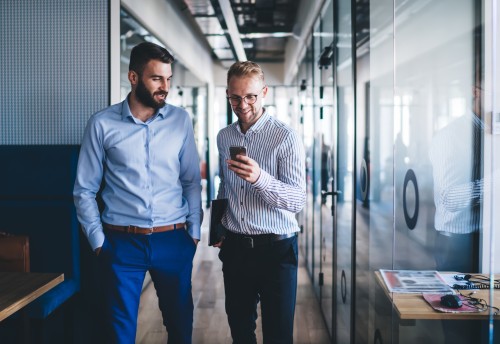 accountants walking and looking at phone