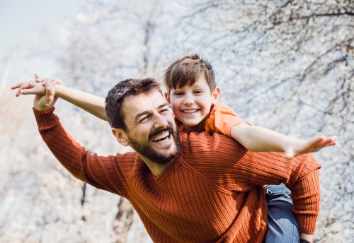 Man piggybacking a young boy