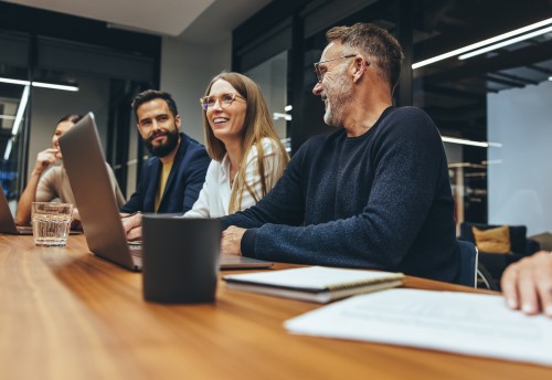 Team of 3 young professionals sitting in a meeting